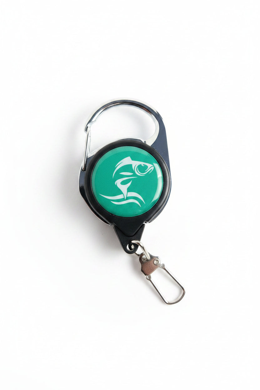 Retractable keychain with green label on a wooden surface