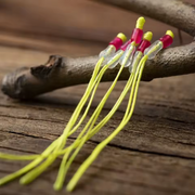 yellow loops for fixed line fishing against a wood background