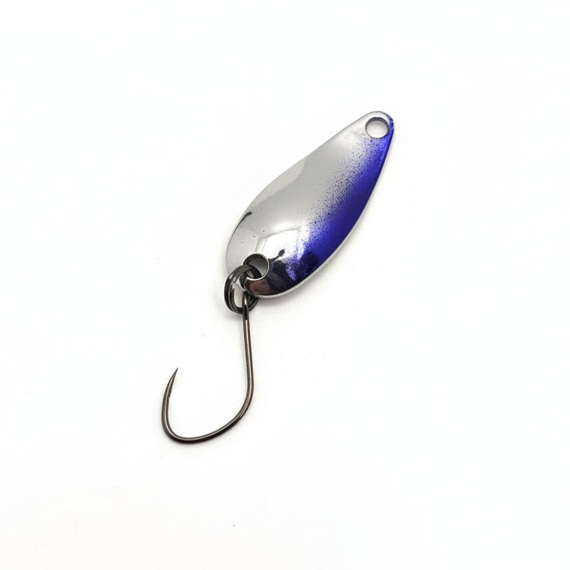 Metallic fishing lure on a white background