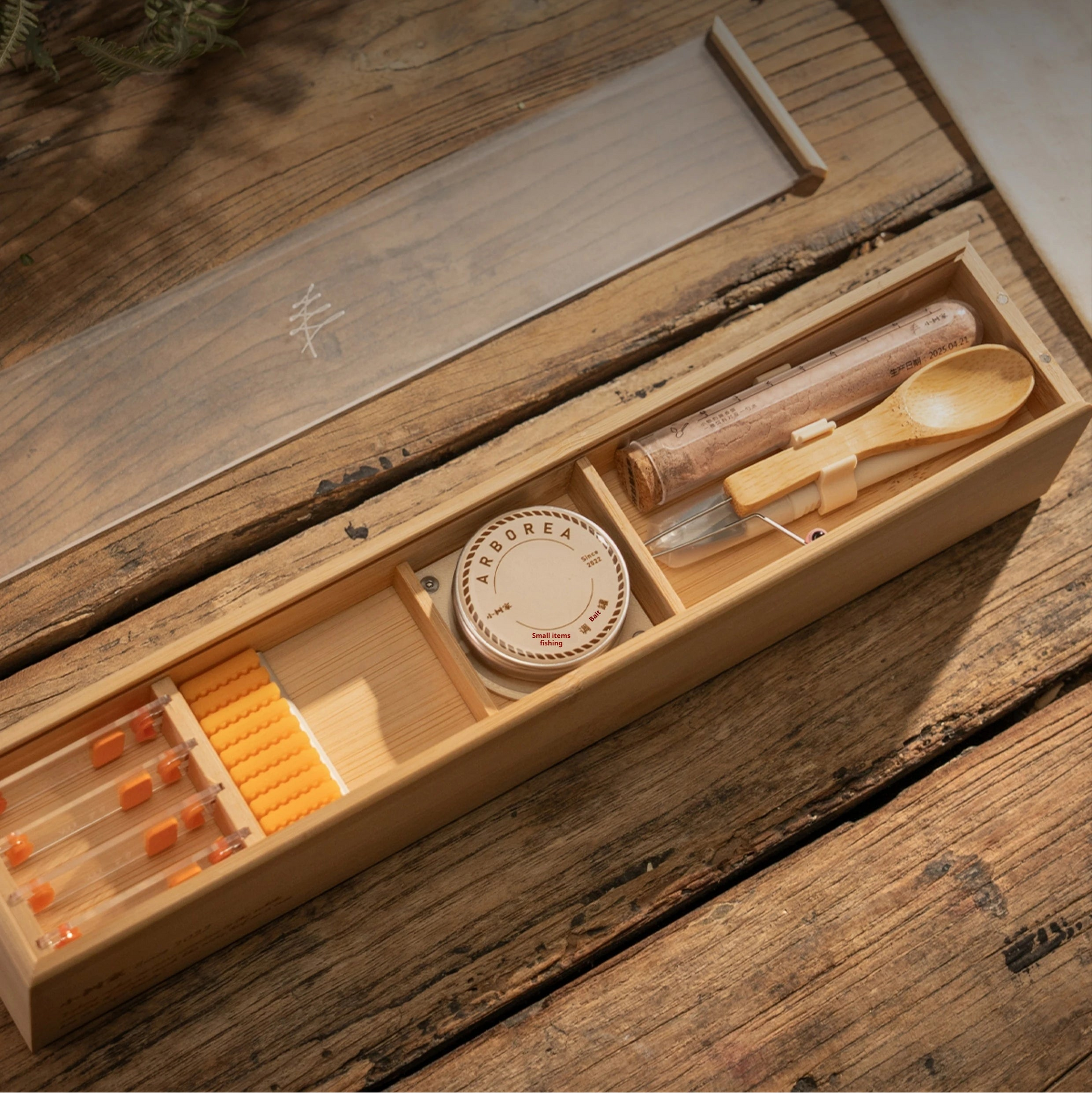 complete micro fishing kit in a bamboo box on a wooden table