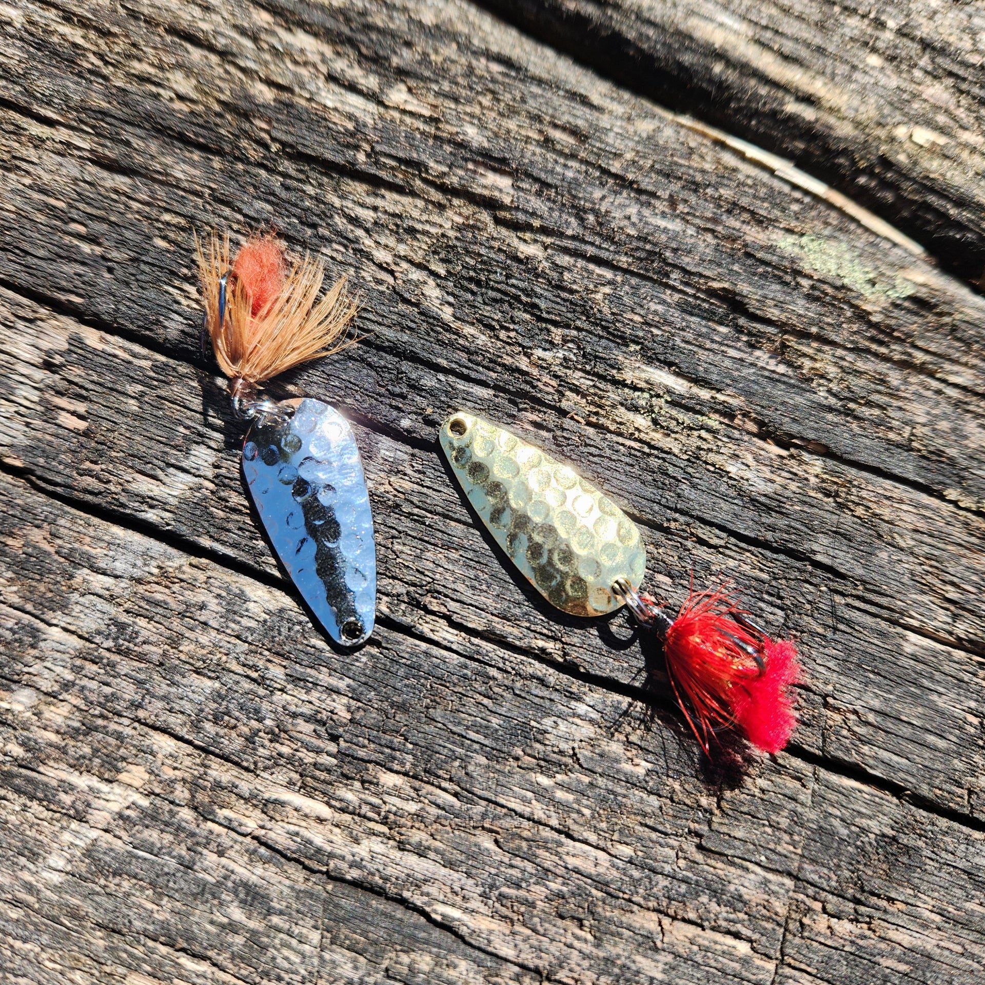 nickel and gold spoons with flies attached