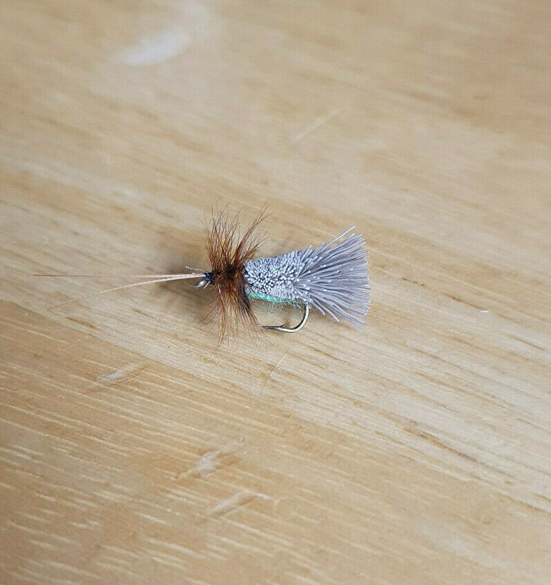 goddard sedge dry fly on a wooden background