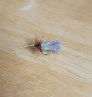 goddard sedge dry fly on a wooden background